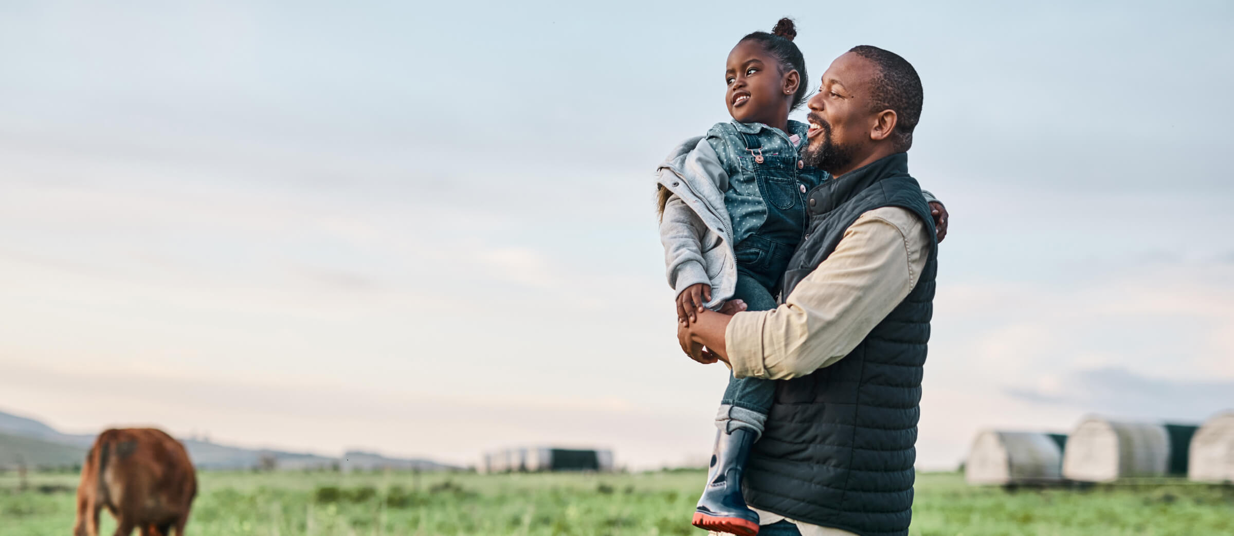 Father and daughter standing in organic field